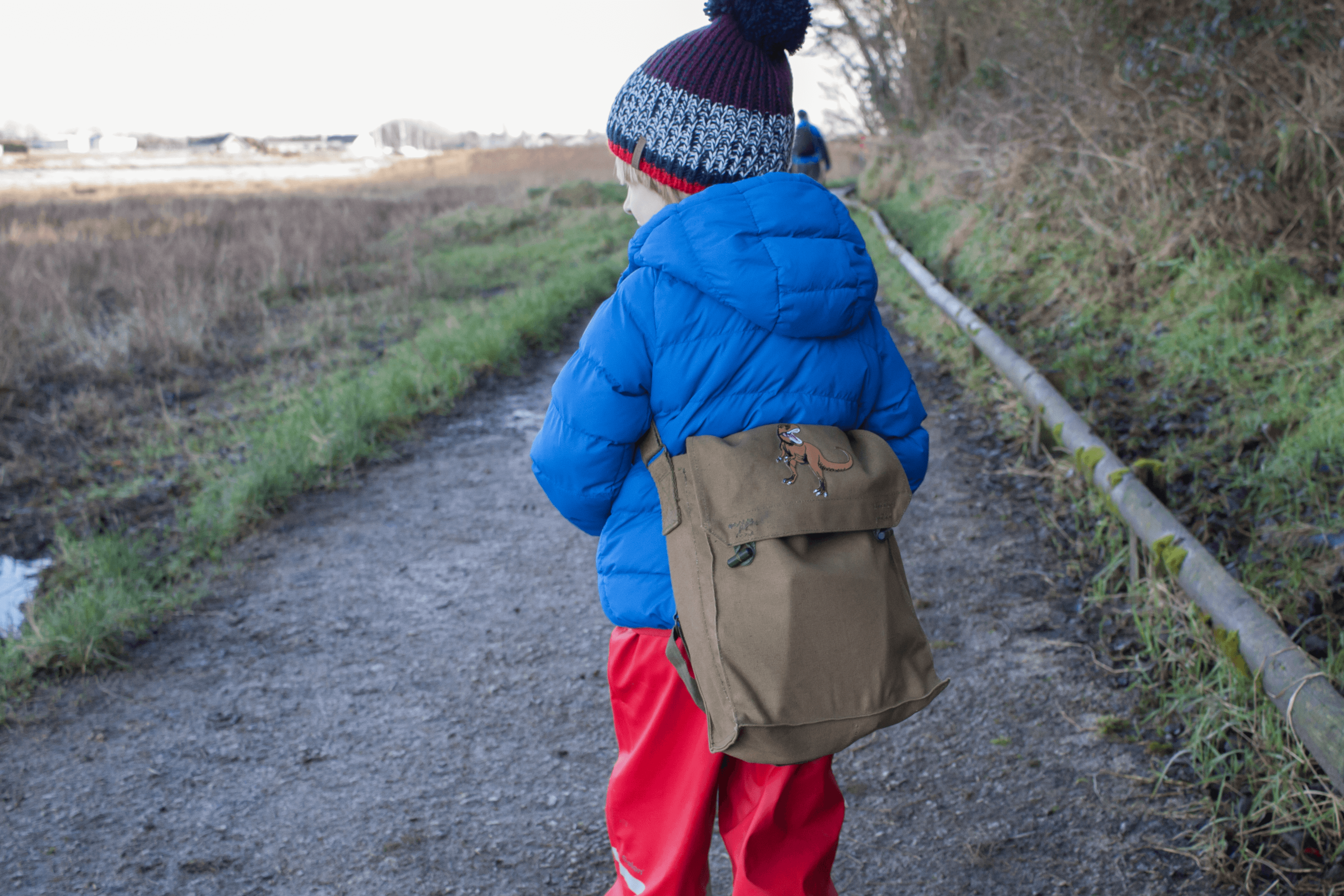 Toby enjoying a winter walk with his Dinosaur Hunting Kit