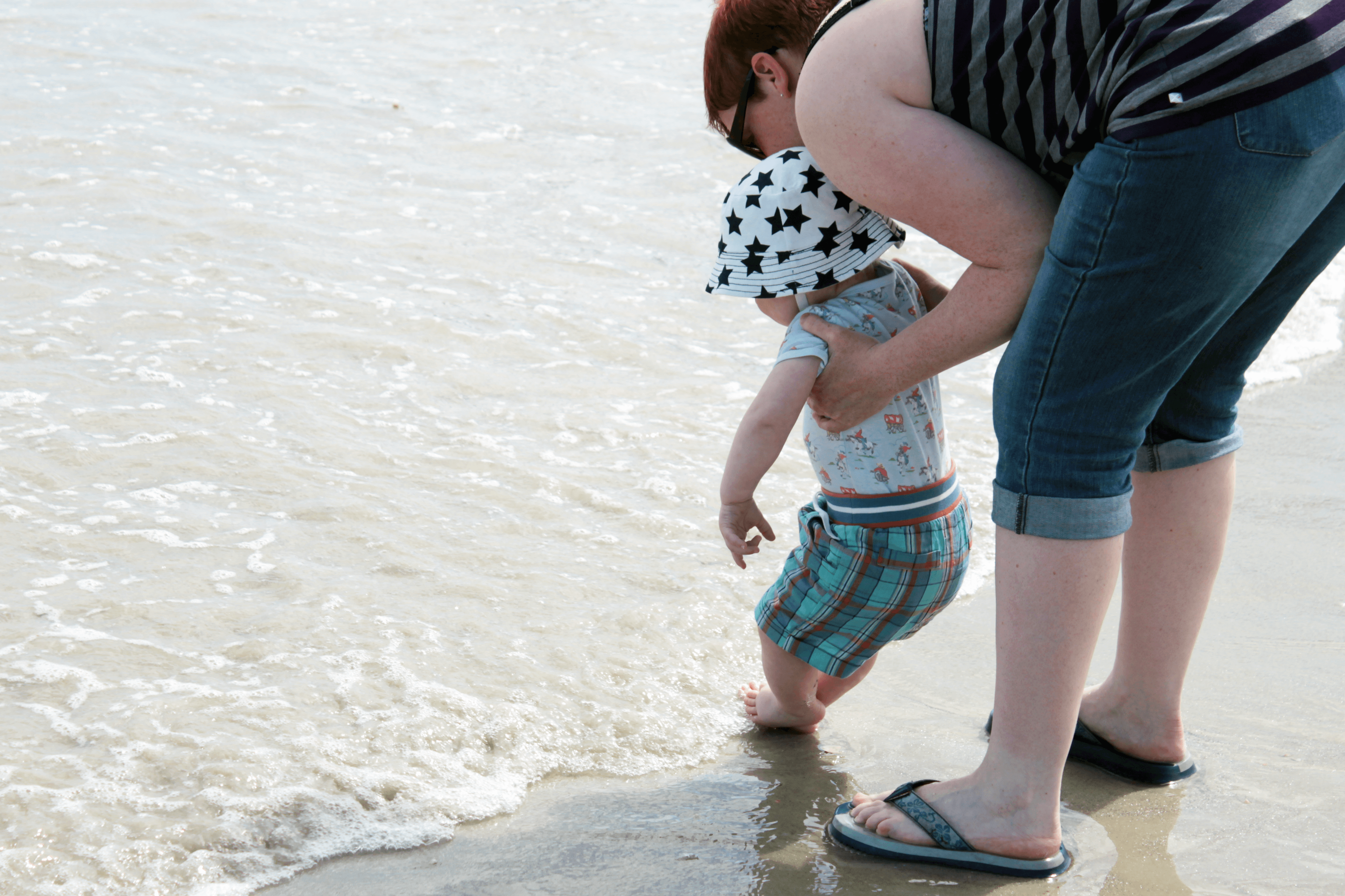 Dipping toes in the sea in France - great holiday destination with kids