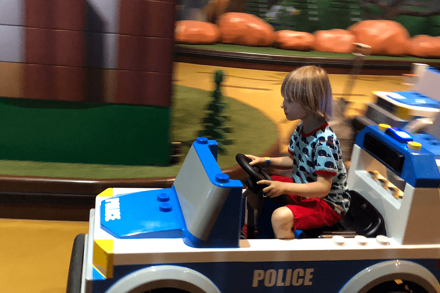 Toby driving a police car at LEGOLAND Discovery Manchester
