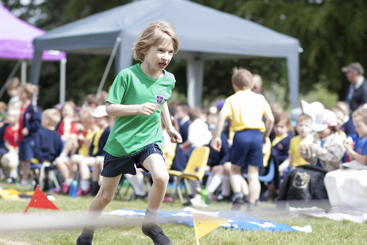 Toby racing for the finish line in the obstacle race at school sports day
