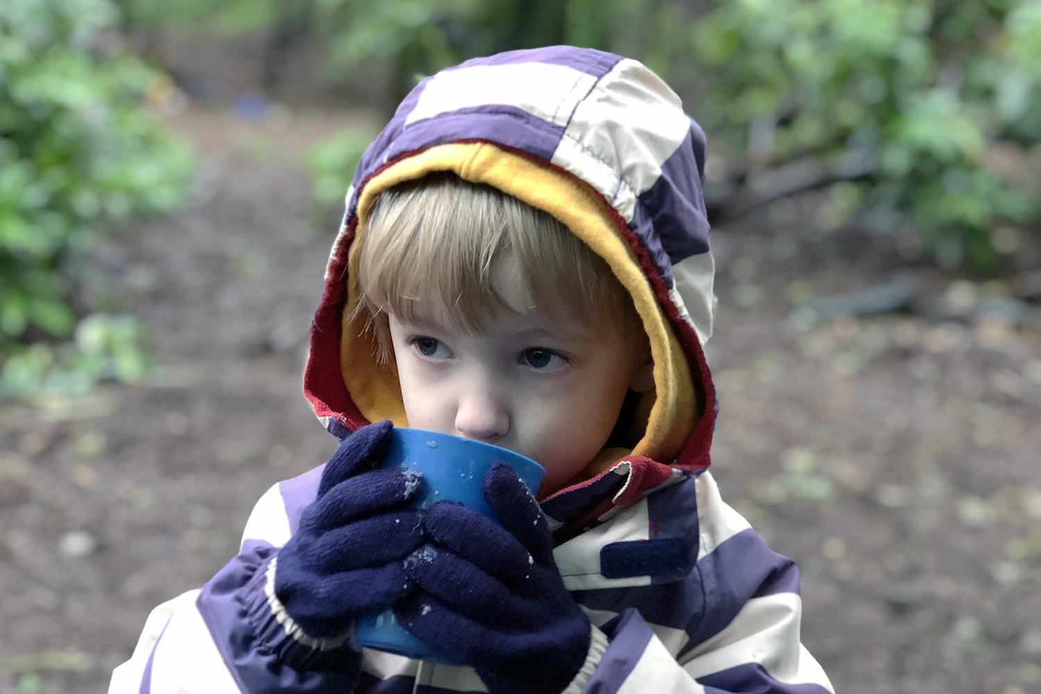 Gabe drinking hot chocolate at forest school