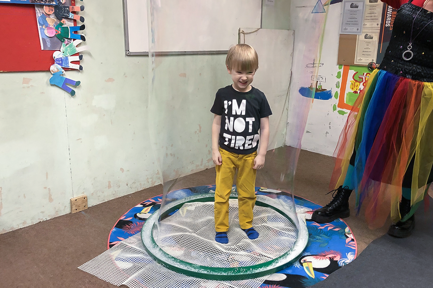 Boy standing inside a giant bubble