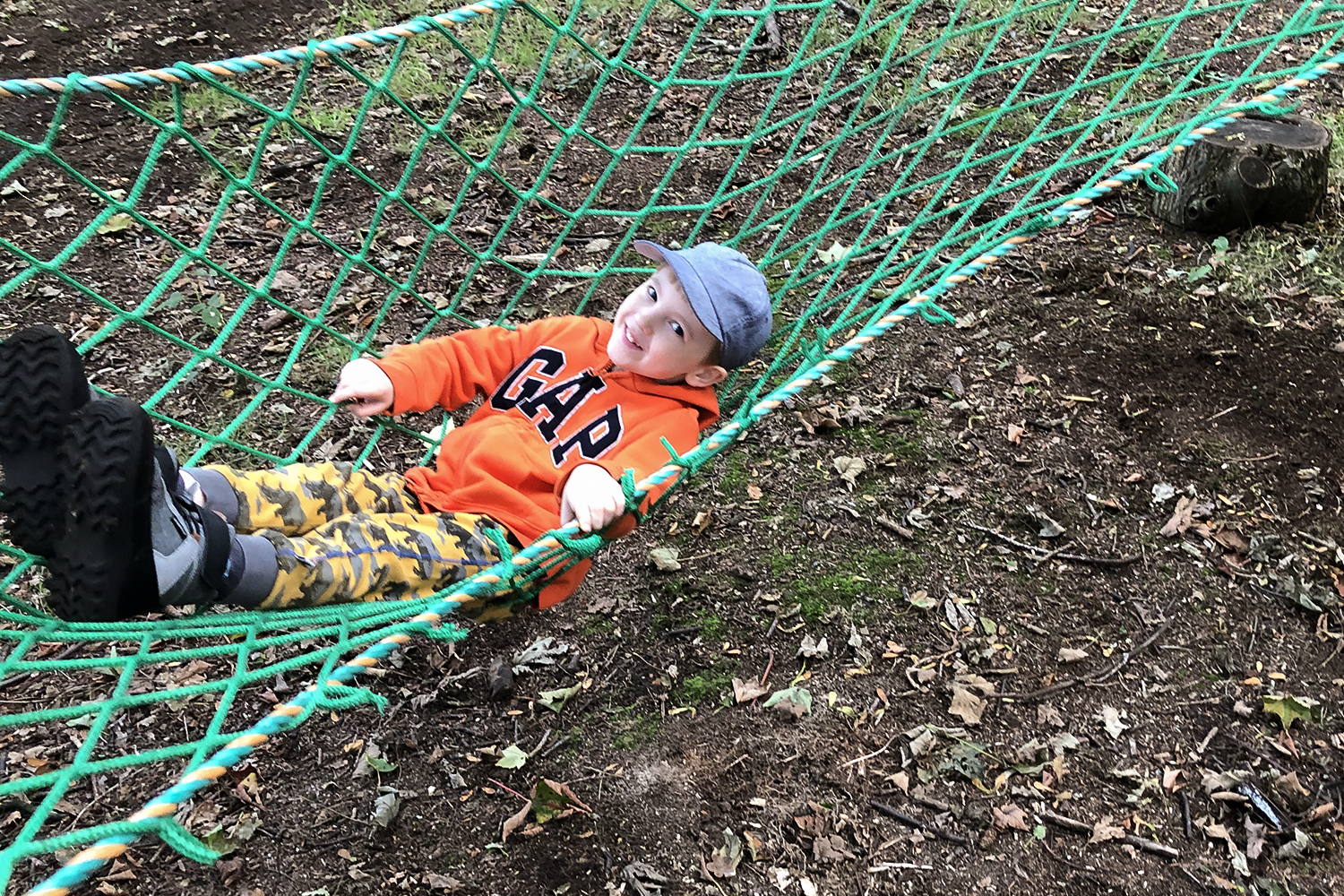 Gabe swinging in a hammock in the woods