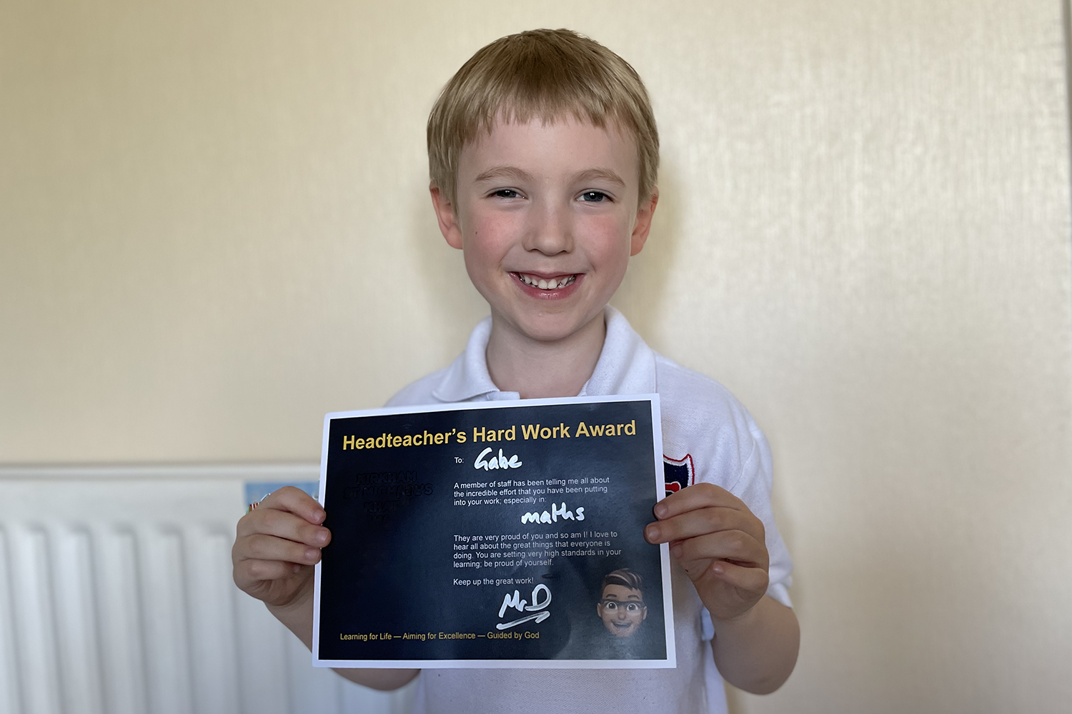 Gabe with a certificate from school