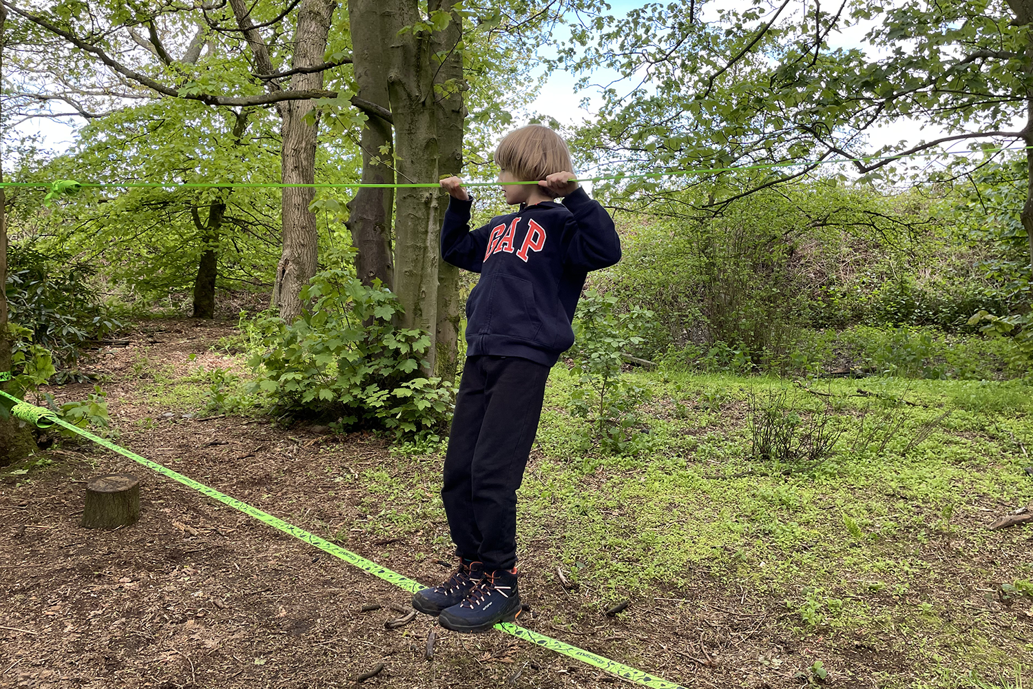 Toby on the slack line in the woods