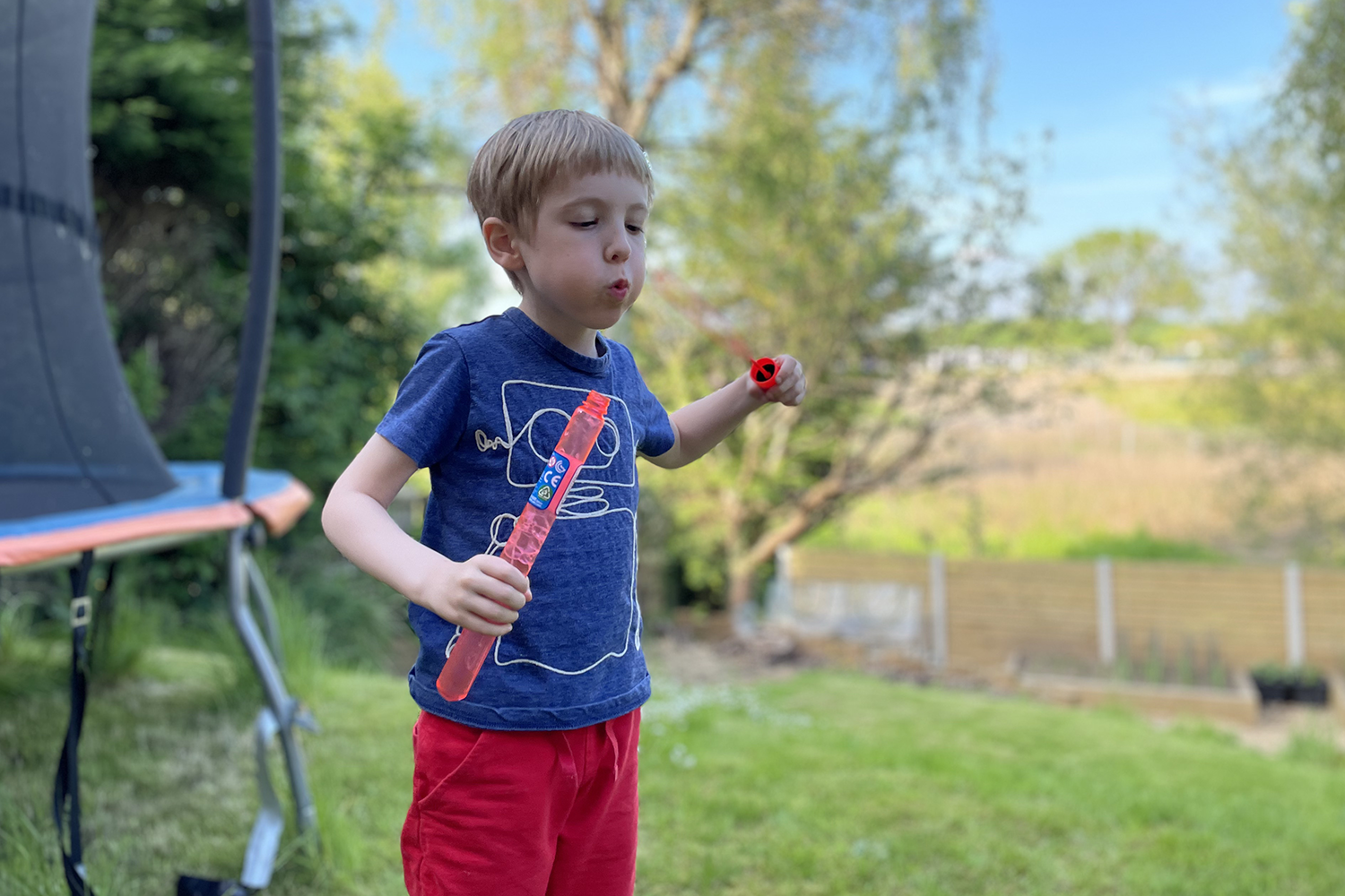 Gabe blowing bubbles in the garden