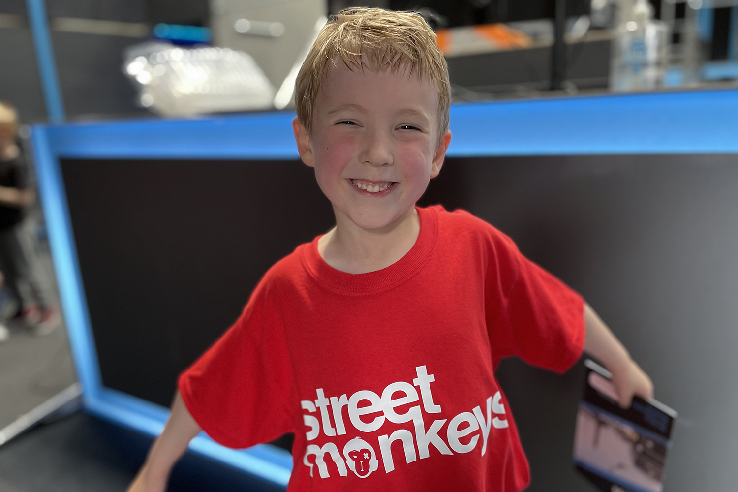 Gabe showing off his new red Street Monkeys t-shirt