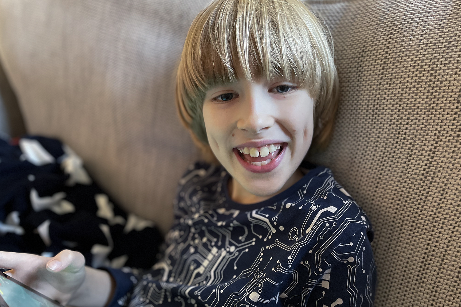 Toby wearing pyjamas and smiling at the camera