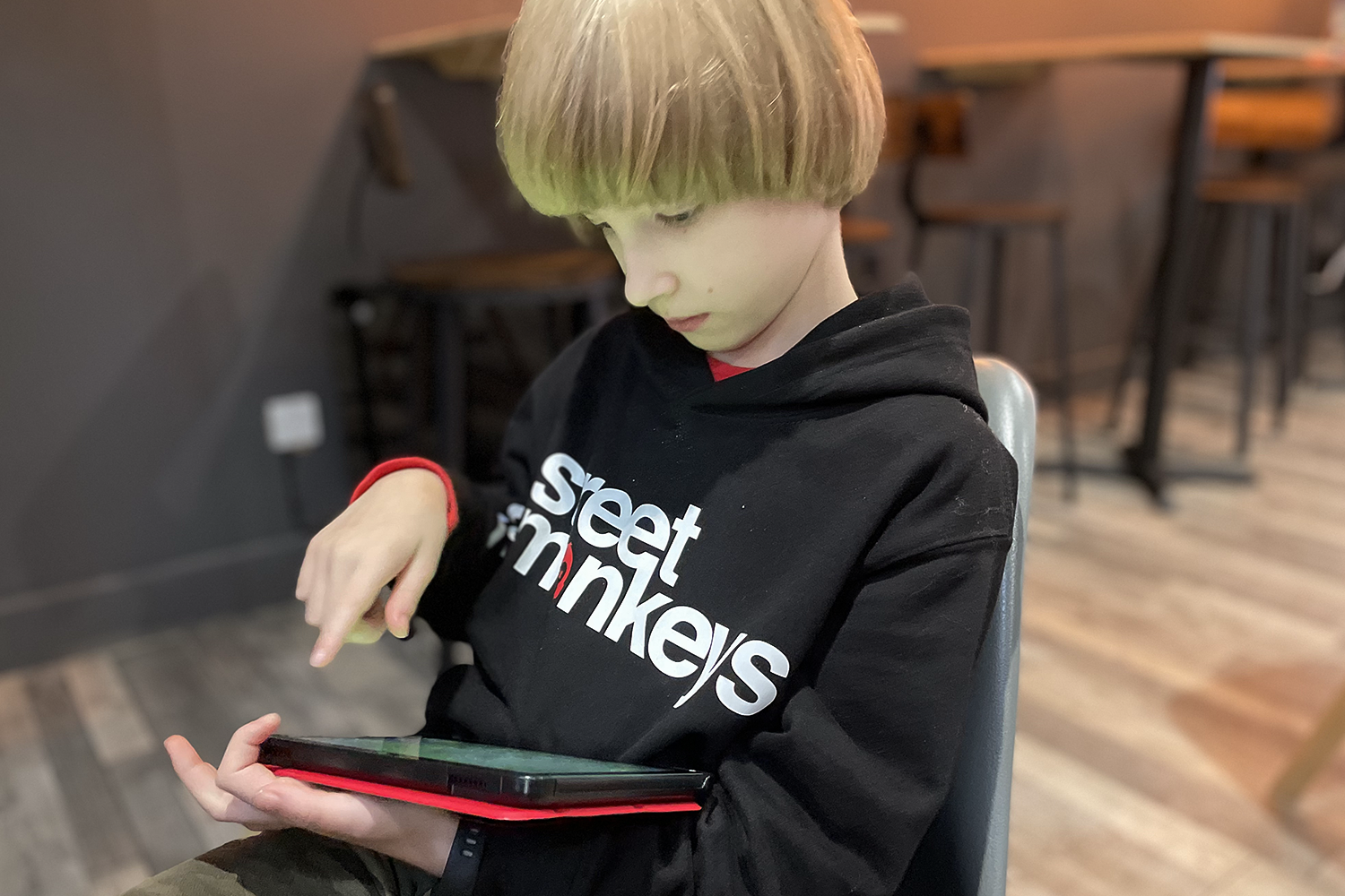 Toby playing on his tablet at Street Monkeys