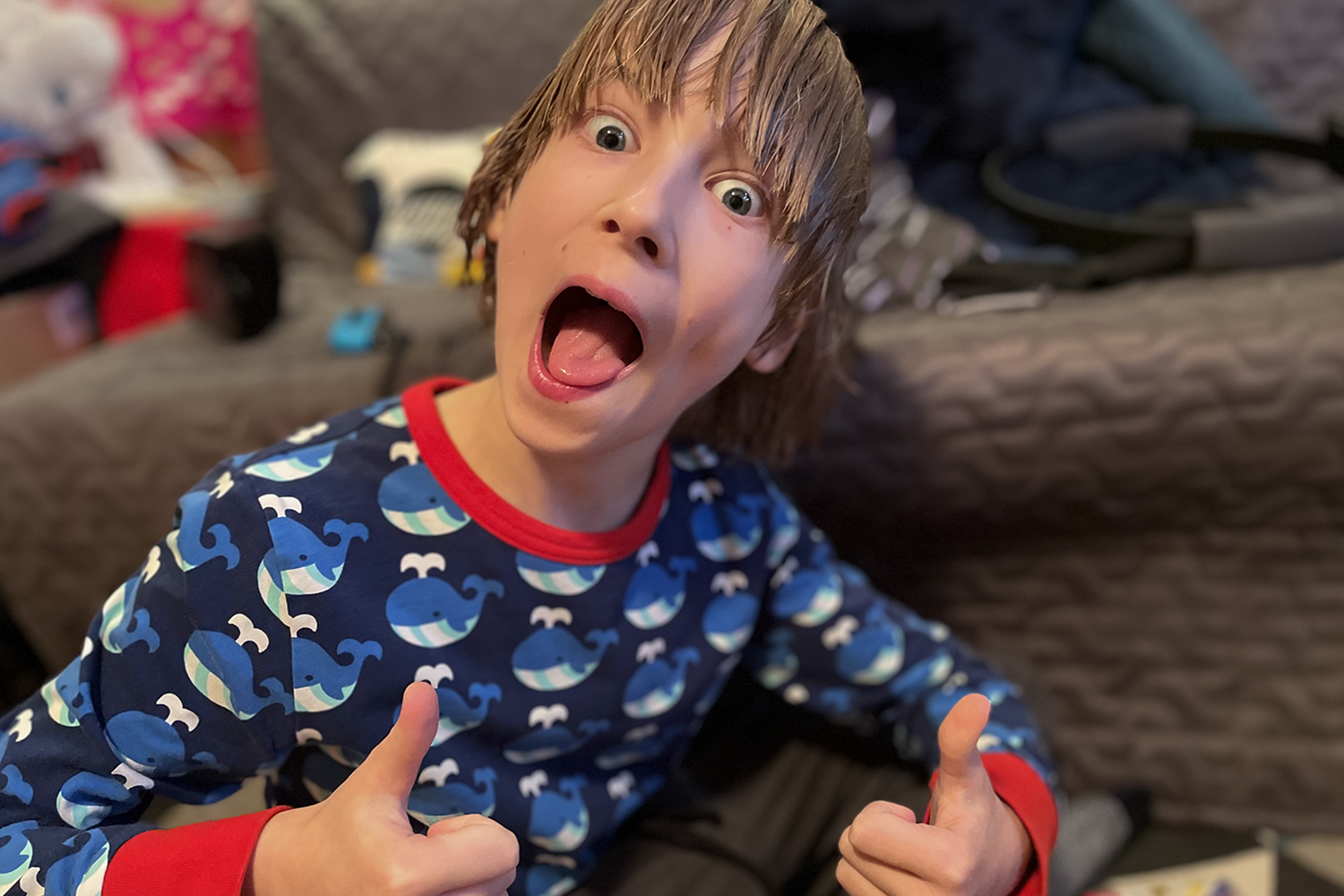 Toby with wet hair, both thumbs up and pulling a silly face
