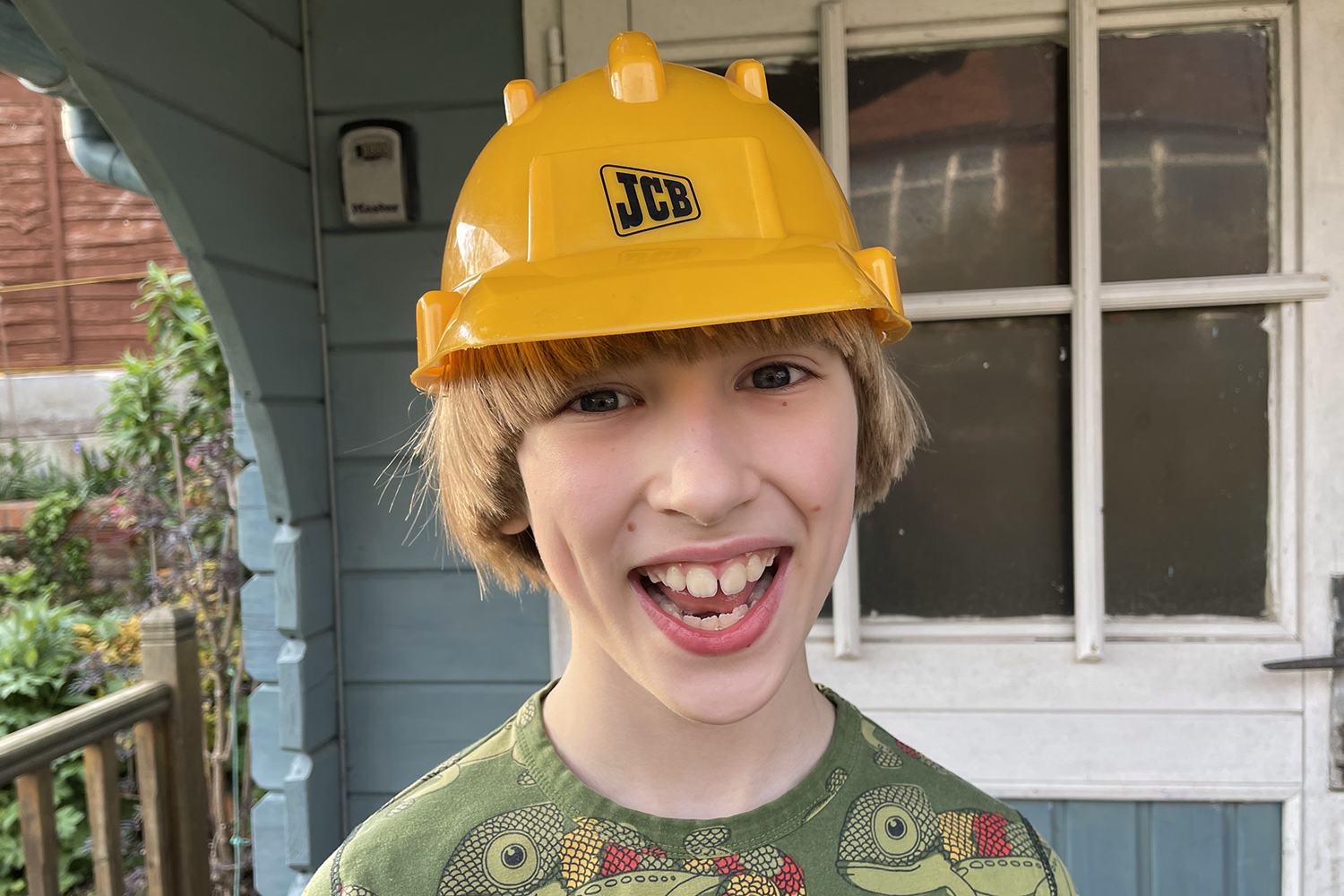 Toby wearing a dress up builders hard hat