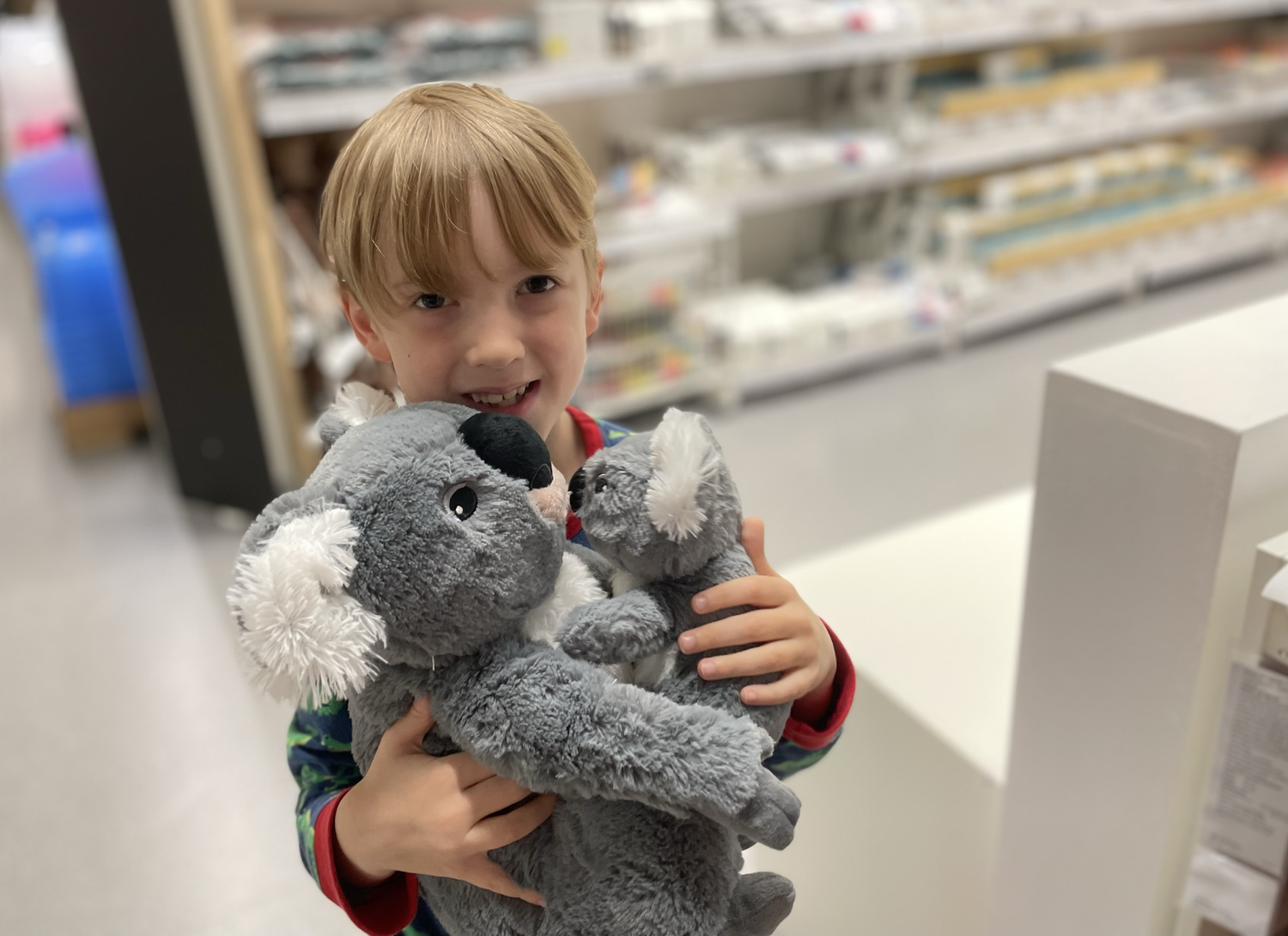 Gabe with a koala soft toy in IKEA